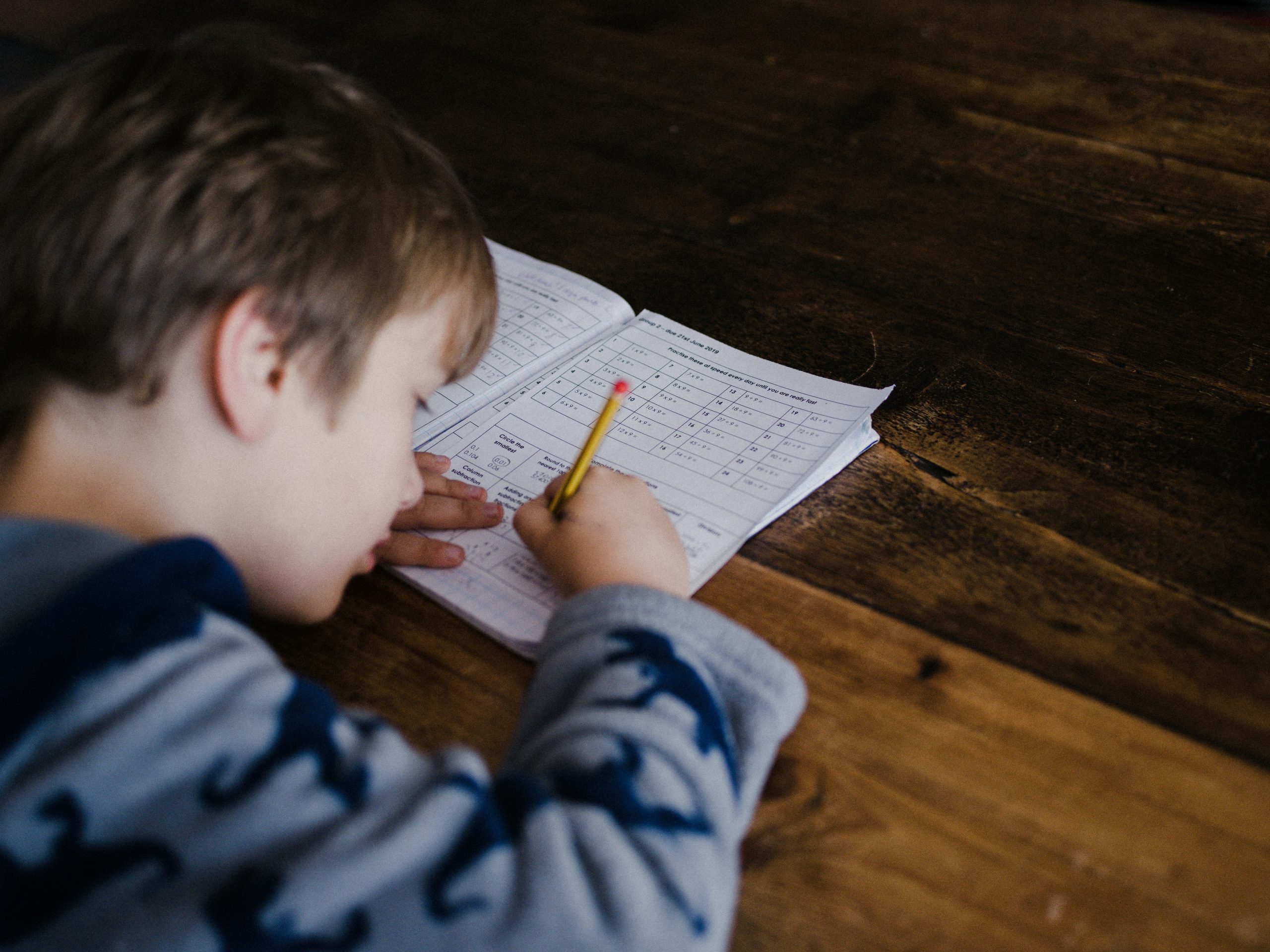 A child completing written work, focused on the task rather than the mark it will receive