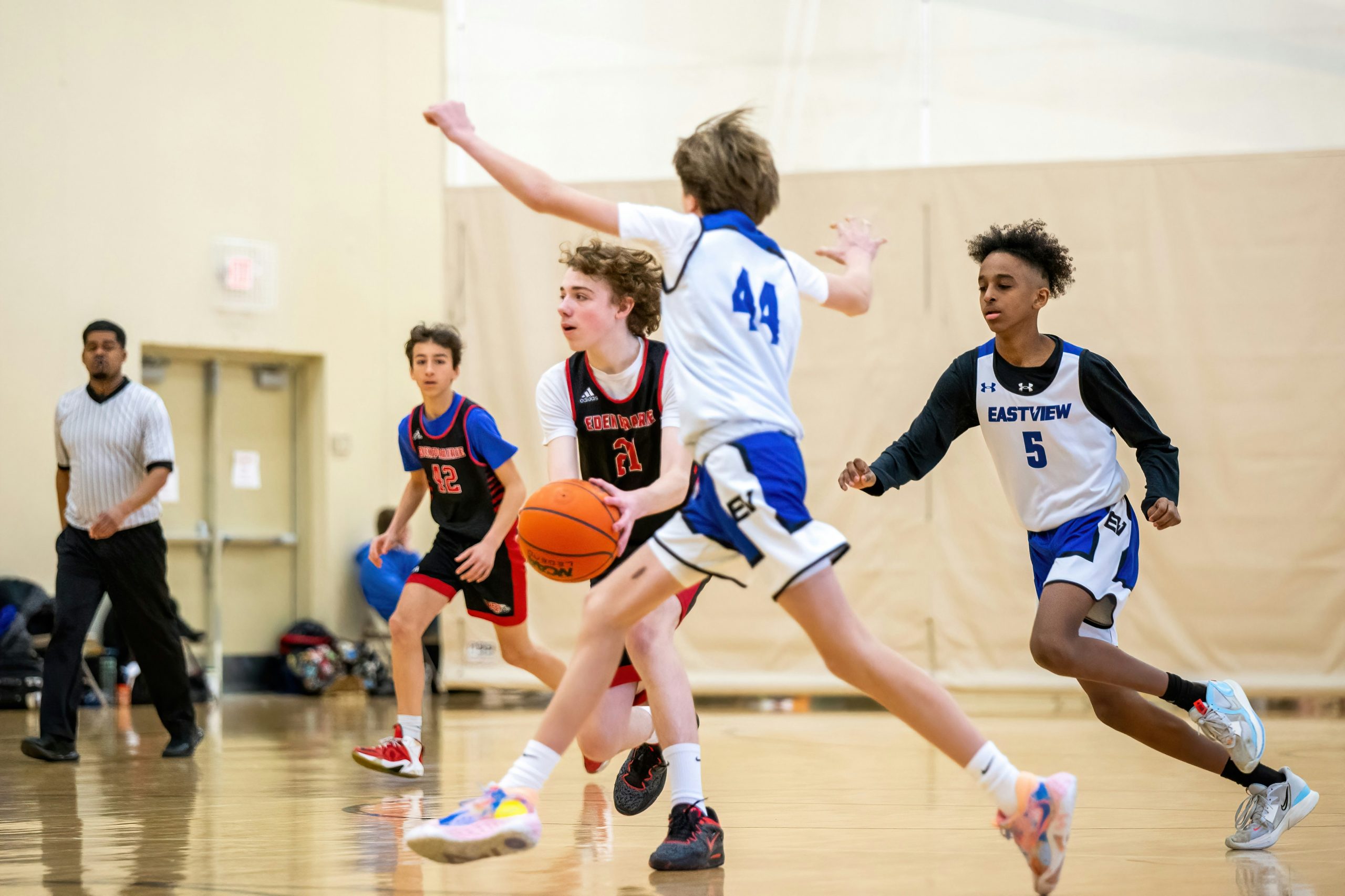 Students playing basketball together at school, competing and responding to setbacks in real time