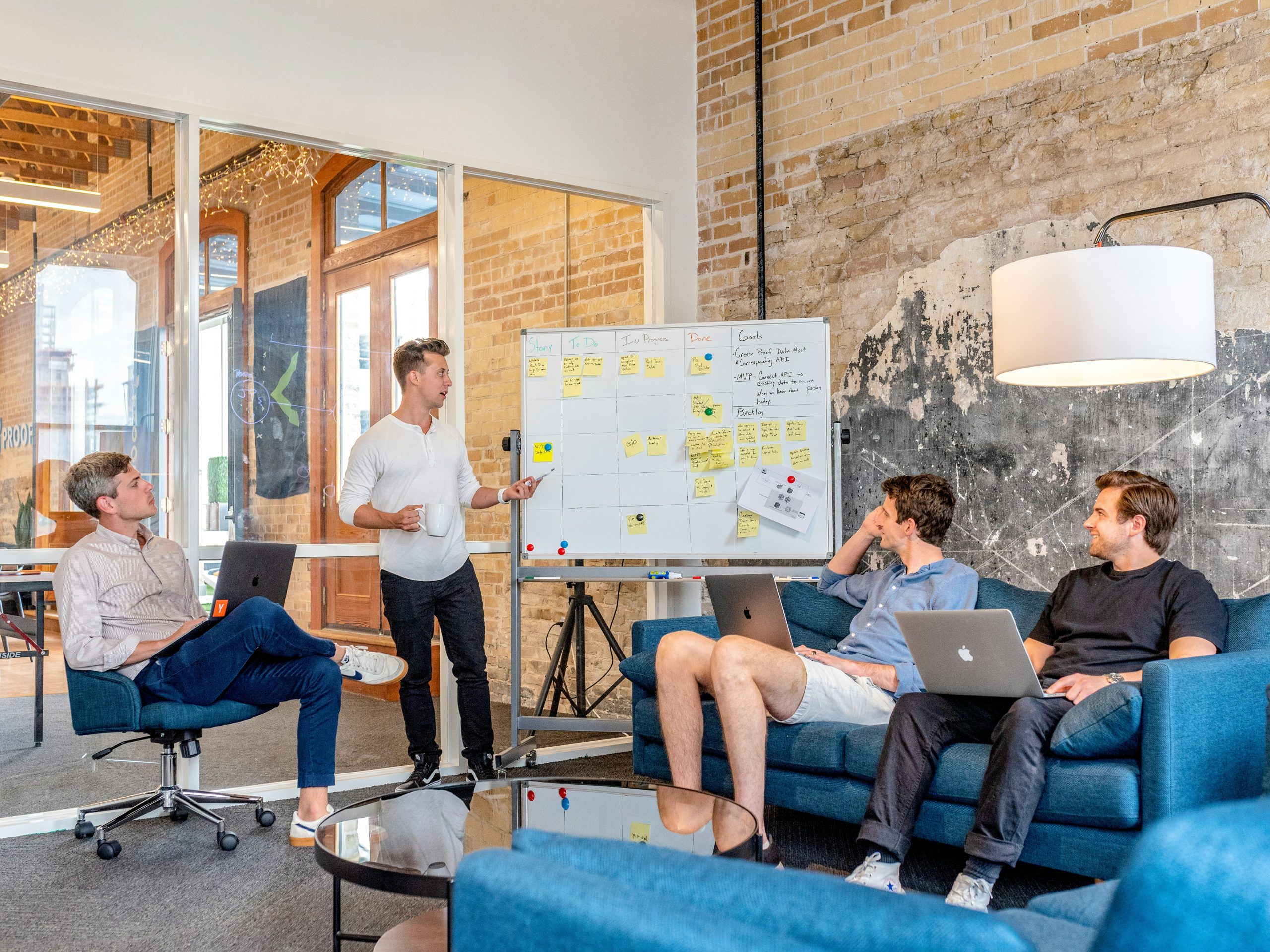 A team gathered around a whiteboard during a goal-setting session