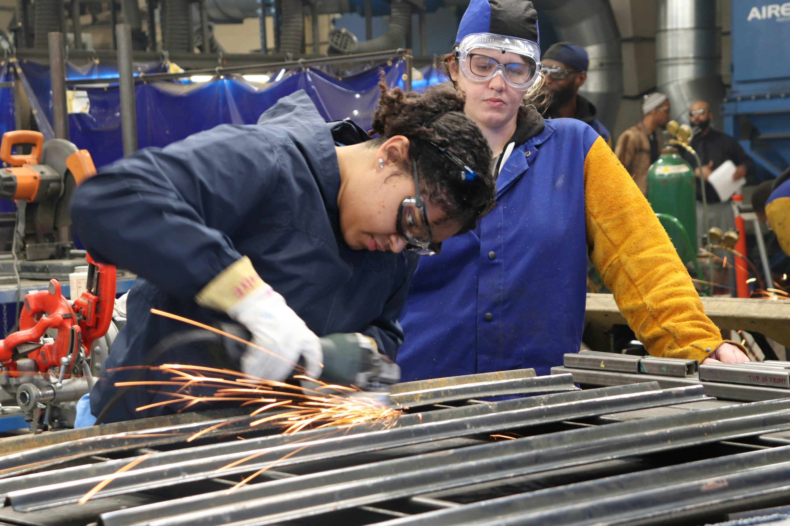 A vocational education student in a technical training uniform