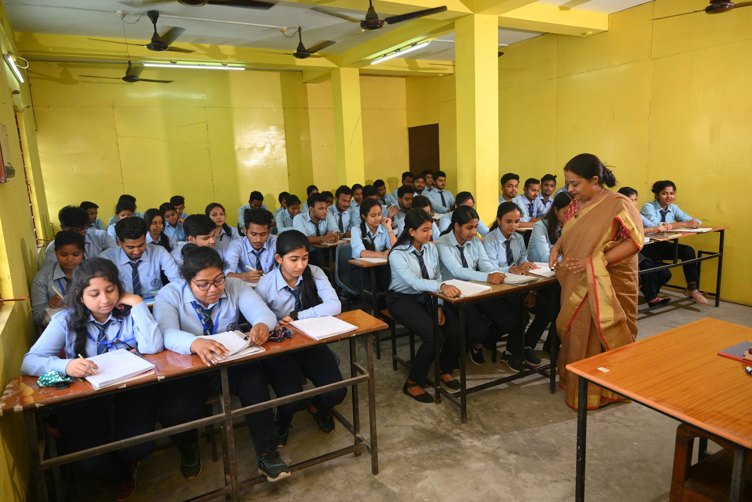 A classroom full of middle-school-age students sitting at desks